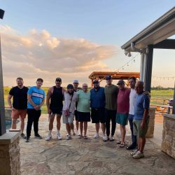 several clients at Ranch House Recovery posing for the photo, with a beautiful sky background on a ranch in Texas. The group is a part of the residential drug and alcohol rehab center in Texas.